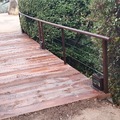 Puente de durmientes con pasamanos envejecido.